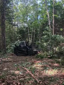 A machine performing ground work in the woods