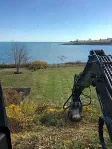 a seaside landscaping machine performing ground work