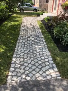 professionally installed stone walkway leading up to a home